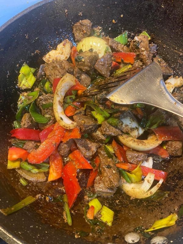 Seared liver pieces are combined with sautéed onions, bell peppers, and leeks in a skillet for the Gourmet Blend recipe.