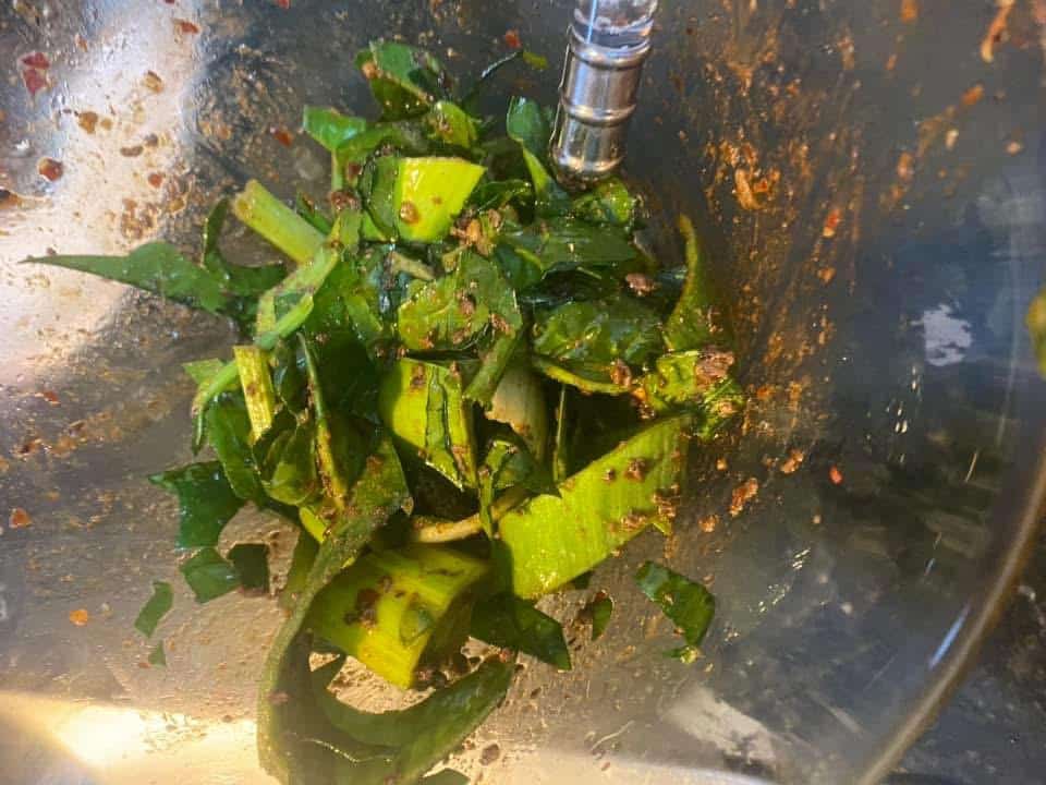 Fresh green vegetables seasoned with spices in a mixing bowl, ready to be sautéed for the Gourmet Blend recipe
