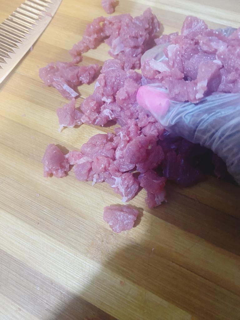 Savory minced meat filling with garlic paste, spring onions, and seasoning for cabbage wraps