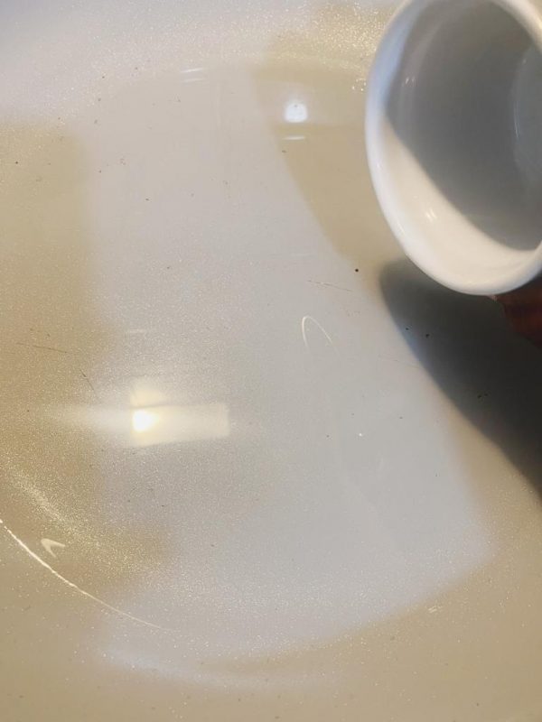 White bowl with ingredients being prepared for a seasoning paste.