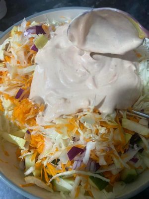 Shredded cabbage, carrot, and onion topped with creamy mayonnaise and ketchup.