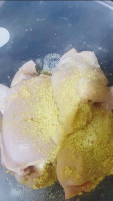 Raw chicken pieces marinated with seasoning cube, salt, pepper, and vinegar