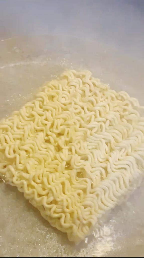 Noodles boiling in a pot of water