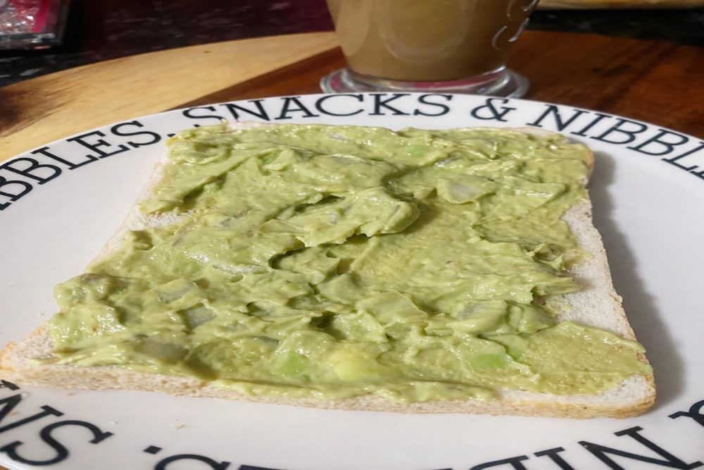 Creamy mashed avocado spread evenly on bread