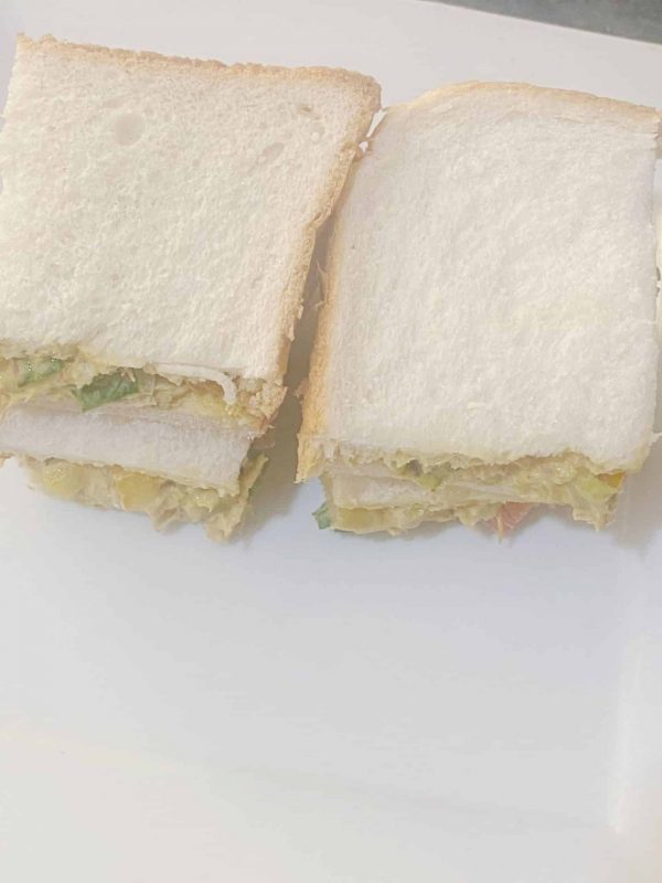 Creamy mackerel rillettes sandwich cut in half on a plate ready to serve