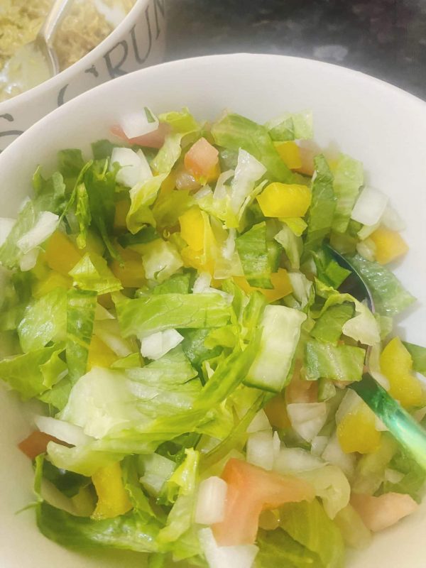 Chopped lettuce cucumber onion and peppers prepared for mackerel rillettes sandwich filling