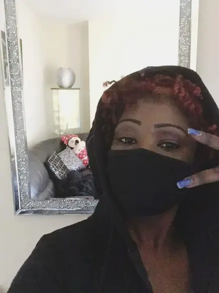 Tima wearing a black face mask and hoodie during the COVID-19 lockdown, a period when she began sharing her home-cooked meals online.