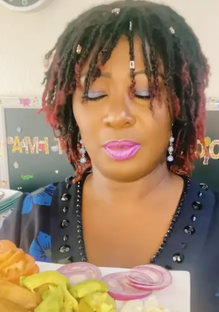 Tima holding a plate of food, expressing gratitude to her supporters and sharing the love behind her home-cooked recipes.